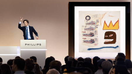 A Phillips auctioneer in front of Jean-Michel Basquiat's "Untitled" during the house's evening sale of Modern and contemporary art in May.