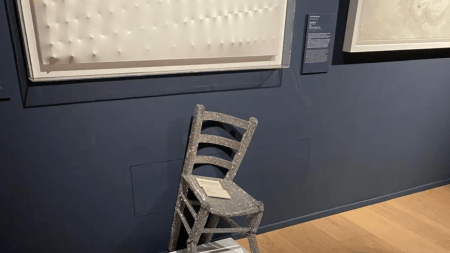 A char encrusted with crystals on a pedastal with broken legs.